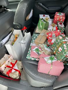 the back seat of a car filled with presents