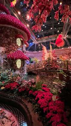 the inside of a flower shop with lots of flowers and plants on display in it