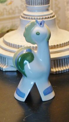 a ceramic giraffe figurine sitting on top of a table