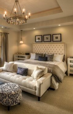 a bedroom with a large bed and chandelier