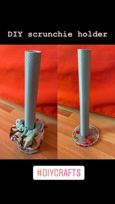 two tall vases sitting on top of a wooden floor next to each other in front of a red wall