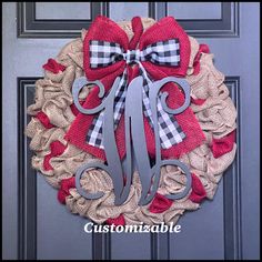 a red and white burlock wreath with monogrammed letters