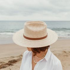 A little western and a little unexpected in the best ways - meet the Moonlight straw rancher, a statement hat that's not just for country concerts and riding horses. Part of our premium straw hat collection, the Moonlight is handcrafted with fine tripilla palm straw that's been sustainably harvested by artisans in Puebla, Mexico. Wear this straw hat for a long day outdoors, offering UPF 50+ sun protection and a large, structured, 4" brim to help shield your face from harmful rays. The cattleman style crown and toasted caramel straw color, gives the Moonlight that special western feel - complete with a removable, 100% genuine leather hatband with a gold hardware finish. Each handmade hat is unique and may have small imperfections or vary in size and color. • Organic and Plastic-free • Produ Woven Straw Panama Hat For Rodeo, Straw Woven Panama Hat For Rodeo, Woven Wide Brim Straw Hat For Rodeo, Wide Brim Woven Straw Hat For Rodeo, Natural Hat Band With Flat Brim For Country Events, Natural Woven Fedora For Rodeo, Western Straw Hat With Wide Brim, Adjustable Straw Hat With Flat Crown For Country Events, Western Wide Brim Woven Straw Hat