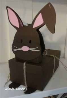 a cardboard bunny sitting on top of a box