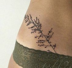 a tattoo on the side of a woman's stomach