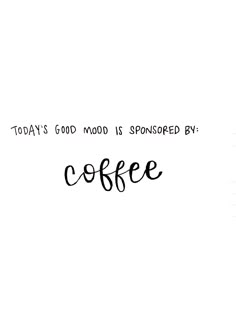 a coffee cup sitting on top of a wooden table next to a white wall with the words, today's good mood is sponsored by coffee