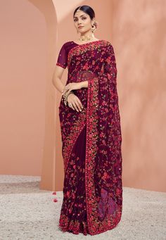 Georgette Saree with blouse in Wine colour 1331  Desc:  Color : Wine Fabric : Georgette Work : Embroidery Wash Care : Dry clean Sleeve Style : Short Sleeve Long Sleeves : Done only in Custom Stitch Sleeves Lining : Done only in Custom Stitch Bust Size : 32 to 42 Inches Occasion : Festival   Diwali   Eid   Durga Pooja   Ganesh Charturthi   Dussehra. With Express Free Shipping and Custom Stitching, Buy Indian Party wedding wear Bridal Sarees Georgette Saree with blouse in Wine colour 1331 online i Purple Georgette Blouse With Intricate Embroidery, Purple Embroidered Georgette Blouse Piece, Embroidered Purple Georgette Blouse Piece, Purple Floral Embroidered Georgette Traditional Wear, Purple Semi-stitched Saree With Floral Embroidery, Festive Purple Georgette Blouse, Purple Saree With Floral Embroidery, Festive Purple Blouse With Dupatta, Purple Floral Embroidered Semi-stitched Saree