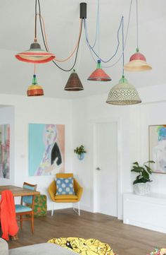 a living room filled with furniture and hanging lights