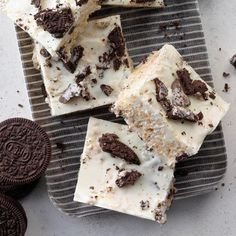 several pieces of cake sitting on top of a plate next to oreos and cookies