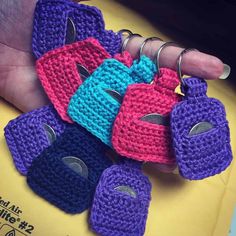 a person holding several small crocheted items in their hands