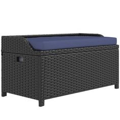 an outdoor wicker bench with blue cushion on the top and bottom part of it