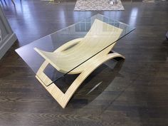 a glass table sitting on top of a hard wood floor