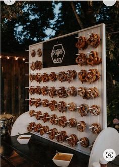 there are many donuts that are on the table and in front of it is a sign