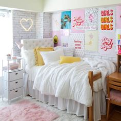 a bedroom with pink and yellow decor on the walls, white bedding and pillows