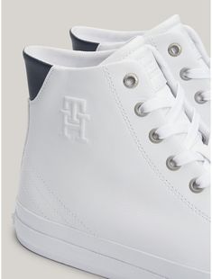 Tommy Hilfiger men's sneaker. Hit the streets running with these casual lace-up sneakers, emboldened by a high-top leather construction and our TH monogram embossed on the side.  Material: 100% Leather (fwa). Th Logo, Tommy Hilfiger Store, Leather High Tops, Kids Sale, Casual Lace, Tommy Hilfiger Man, Jeans For Sale, On The Side, Shoe Box