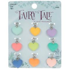 six heart shaped charms in different colors on a white card with the words fairy tale