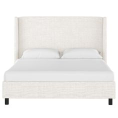 a bed with white linens and pillows on it's headboard, against a white background