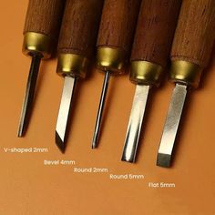 four knives are lined up in a row with different sizes and widths on them