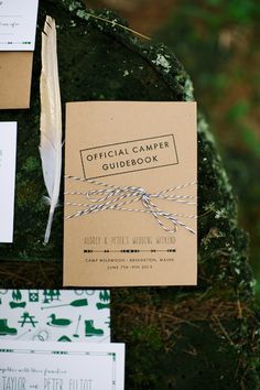 the wedding stationery is tied up and ready to be placed on the tree stump