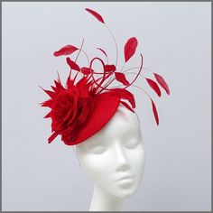 Stunning bright red fascinator/hatinator. A mini disc decorated with a beautiful open linen flower backed by a coordinating red feather flower with a plume of long feathers and curled ostrich quills. Made on a headband. Ideal for ladies day, weddings and other formal events. Please note this hat is made to order, orders take approximately 3-4 weeks to be made. This design is available in other colours on request. All of our designs can be made to order in a range of different colours or styles, Linen Flower, White Fascinator, Green Fascinator, Red Fascinator, Wedding Birdcage, Blue Fascinator, Feather Fascinator, Flower Fascinator, Wedding Fascinators