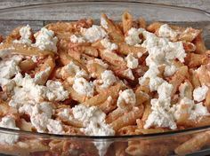 a glass bowl filled with pasta and cheese