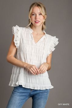 Experience the ultimate comfort and style with our Callie Texture V-Neck Flutter Sleeve! Featuring a unique texture and ruffle neck design, this top is designed to make you stand out from the crowd. With flutter sleeves and a tie detail, it's perfect for any occasion. Upgrade your wardrobe today! Ruffle Neck Design, Plus Size Romper, Rompers For Kids, Living Room Accent Tables, Girls Shoes Kids, Melting Candles, Custom Coffee, Plus Size Jeans, Flutter Sleeves