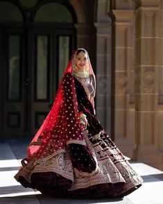 a woman in a red and black bridal gown