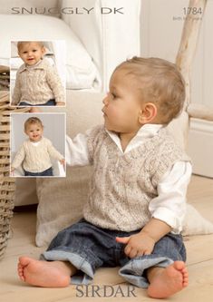 a baby sitting on the floor next to a basket and wearing a knitted sweater