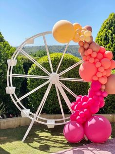 a ferris wheel with balloons attached to it