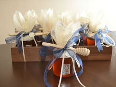 two jars filled with honey sit on top of a wooden table next to each other