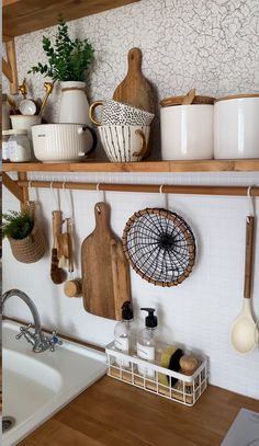 the kitchen shelves are filled with pots, pans and utensils