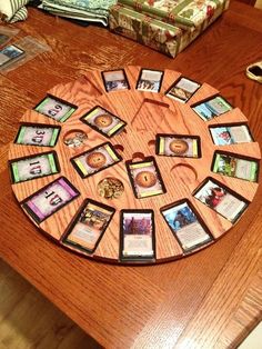 a wooden table topped with pictures and cards