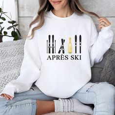 Step out of the ski slopes and into style with this cozy and cute Apres Ski sweater. Featuring an apres ski design, this comfortable skiing sweater is perfect for those chilly days. The colors and unique pattern give this sweater a retro feel. Whether you're lounging around the cabin or hitting the town with your friends, this Apres Ski sweatshirt will keep you warm and looking your best. Information - Gildan 18000 Unisex Sweatshirt - 50% Cotton 50% Polyester - Ribbed knit collar - Printed with the highest quality and durability Care Instructions - Machine wash: warm (max 40C or 105F) - Non-chlorine bleach - Tumble dry on low or lay flat to dry - Do not iron directly into design - Do not dryclean Sizing - Sizes are unisex - It fits true to size, or size up for an oversized fit. - Please re Casual White Sweatshirt For Winter Sports, Winter Sports Sweatshirt, Sporty Sweatshirt For Winter Sports, Casual Winter Skiing Tops, Long Sleeve Ski Tops For Ski Season, Long Sleeve Tops For Ski Season And Winter Sports, Long Sleeve Skiing Tops For Ski Season, White Crew Neck Sweatshirt For Winter Sports, White Long Sleeve Sweatshirt For Winter Sports