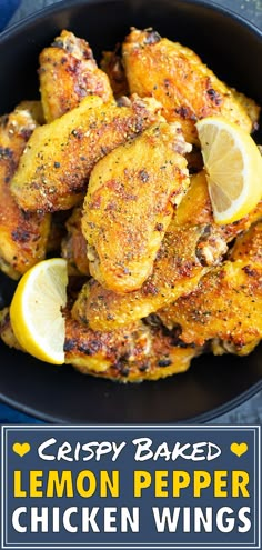 chicken wings with lemons and spices in a black bowl on a blue tablecloth