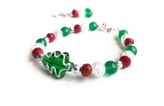 Christmas tree bracelet is fun & festive! Perfect for finishing off your holiday attire quickly and easily. It's bright red, white and green hues makes an impressive statement around your wrist. With this Christmas jewelry set you can be festive & fashionable! Christmas Jewelry for Women * Christmas tree gifts for her! * Christmas tree lampwork bead * Colorful red, white and green beads * Total length 8.25 inches, Different lengths available on request.  * Made with silver lobster clasp * Strung Tree Gifts, Red And Green Christmas, Red Green Christmas, Holiday Attire, Christmas Bracelet, Green Hues, Green Beads, Christmas Tree With Gifts, Jewelry Christmas