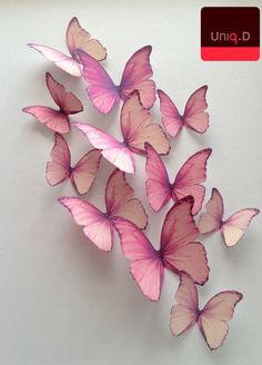 a bunch of pink butterflies flying in the air on a white background with an uno sign above it