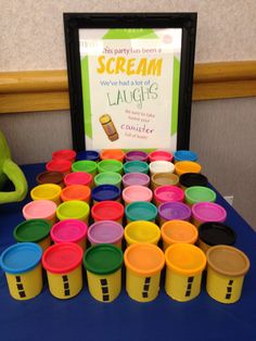 there is a table with cups on it and a sign that says scream we've had the best of laughs