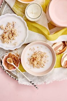 three bowls with oatmeal and spoons on a table