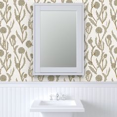 a white sink sitting under a bathroom mirror next to a wall mounted faucet