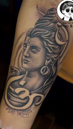 a woman's arm with a tattoo on it that has a buddha in the middle