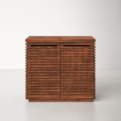 a wooden cabinet sitting on top of a white floor