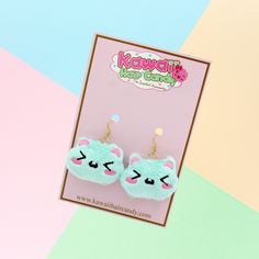 "Now you can have your very wear my super cute kawaii plushes and take with you on all of your adventures!  My kawaii plush cat earrings have been embroidered on the softest minky fabric and are filled with polyester filling.  This listing is for a pastel mint kawaii plushie cat cool anime earrings other colors available in my shop. Perfect for all styles! :)  Use these accessories for an instant update on just about any harajuku clothing style! ♥ Earring Hooks Gold Colored Stainless Steel Wire ♥ Measures approx. 2\" across x 1.5\" high ♥ Designed by & exclusive to Kawaii Hair Candy ♥ Made in the USA ♥ Intended for use by adults only We hope you wear these with every piece of clothing you own!" Kawaii Dangle Earrings With Ear Wire, Kawaii Drop Earrings, Kawaii Hypoallergenic Drop Earrings, Handmade Green Kawaii Earrings, Kawaii Style Drop Earrings, Kawaii Dangle Earrings, Japanese Earrings, Cat Plushie, Kawaii Hair