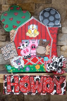 the farm sign is decorated with farm animals