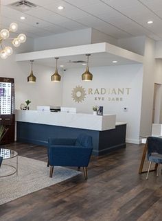 an office lobby with blue chairs and lights