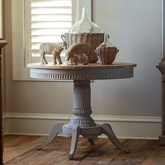 a table that has some baskets on it and two sheep figurines sitting on top of it