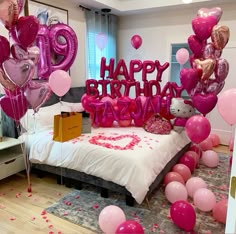 a bedroom decorated with balloons and streamers for a happy birthday