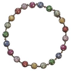 A unique and modern bead necklace featuring multicolor gemstones set in a pave fashion with diamond accents. The necklace has a total of 21 balls including the clasp. Each ball is set with natural stones : Blue sapphires, pink sapphires, rubies, tsavorite garnets, orange sapphires, green sapphires. The estimated weight of the diamonds is 8.40 carats, HI color SI clarity. The estimated weight of the color stones is 45 carats, with very good color overall. The necklace is set in 18 karat black rho Luxury Multicolor Briolette Necklaces, Luxury Multicolor Briolette Necklace, Luxury Multicolor Round Bead Jewelry, Luxury Multicolor Beaded Jewelry, Luxury Multicolor Polished Beads Jewelry, Elegant Multicolor Multi-stone Beaded Necklace, Formal Multicolor Polished Bead Necklaces, Formal Multicolor Polished Beads Necklace, Pave Beads