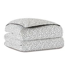 three sheets with black and white dots on them, one is folded up to the side