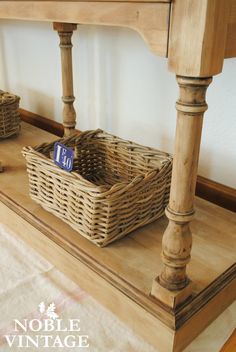 a basket sitting on top of a wooden table next to two baskets with tags in them