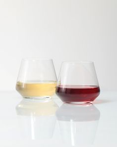 two wine glasses sitting next to each other